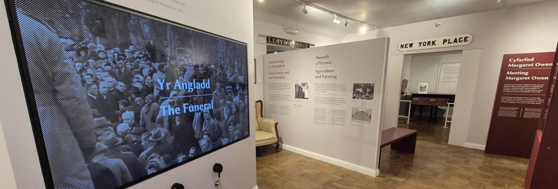 Inside the museum featuring The Funeral television screen