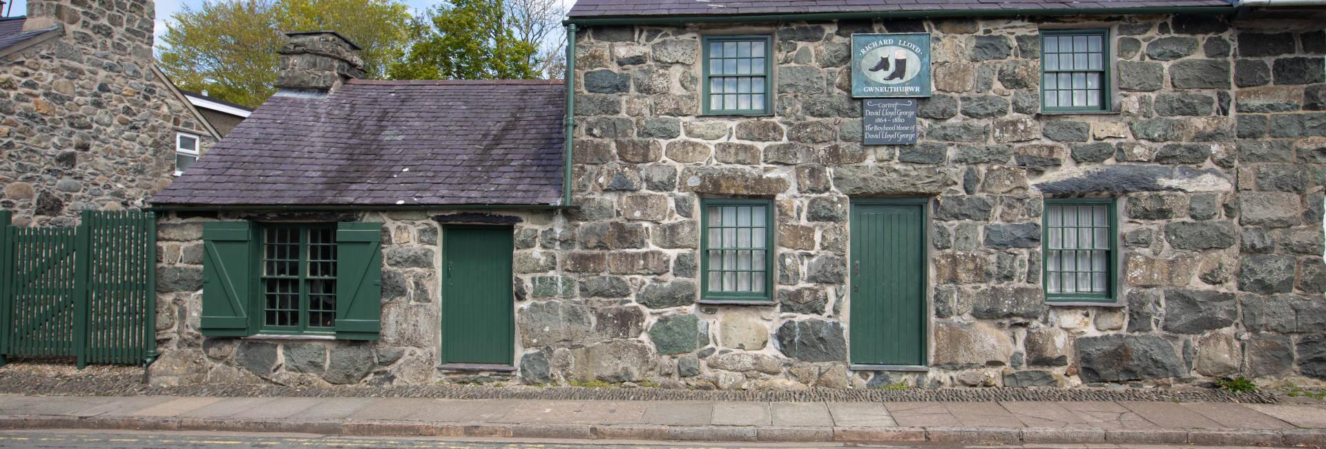 A view of outside the museum showing a stonework building, Highgate cottage